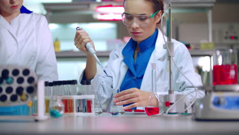 Chemistry-student-in-lab.-Young-chemical-scientist-working-with-chemical-liquid
